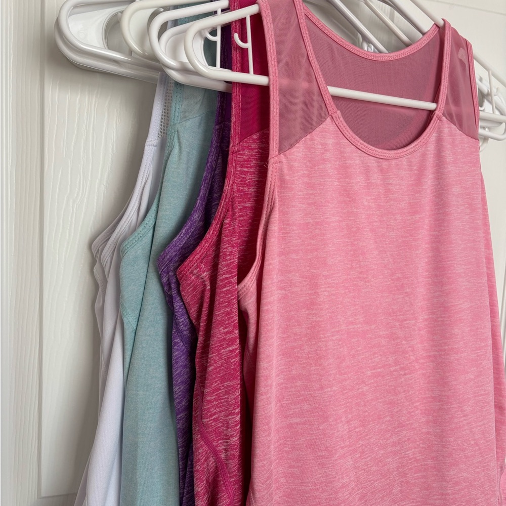 Set of FIVE Sleeveless Women's athletic tops.